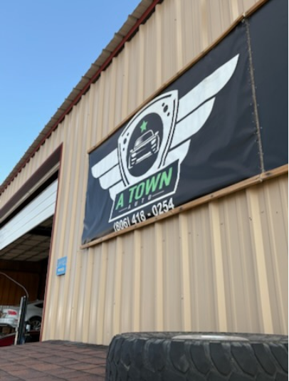 A Town Auto banner on the shop exterior